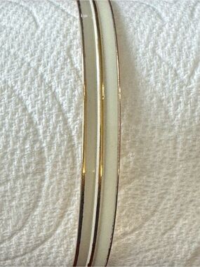 Vintage Monet bangle bracelet in gold tone with a white enamel stripe.